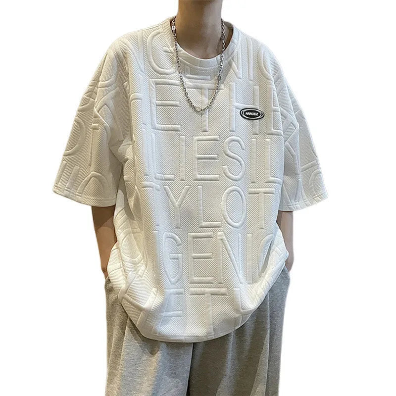 Men's grey loose-fit t-shirt with a raised 3D letter print on the front.