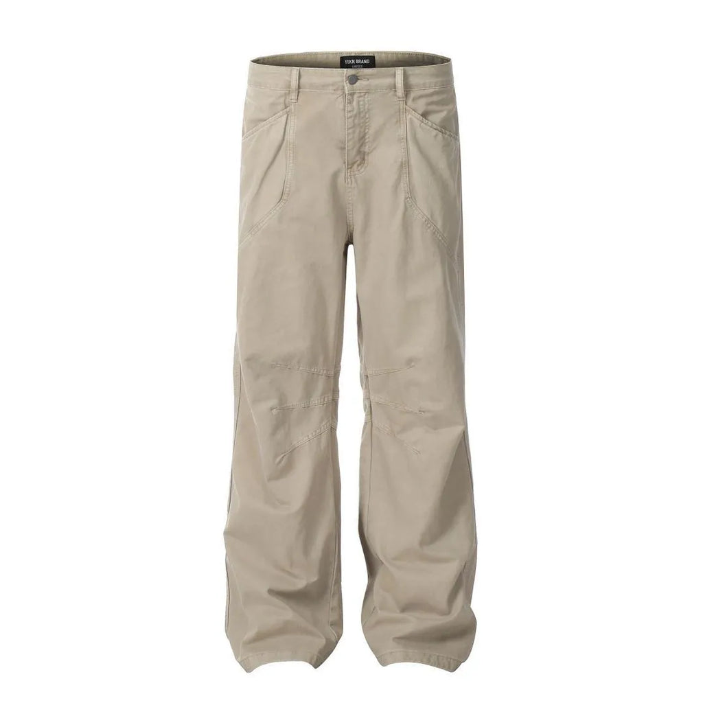 Men's loose straight-leg cotton trousers in brown colour with a high waist and wide leg opening.
