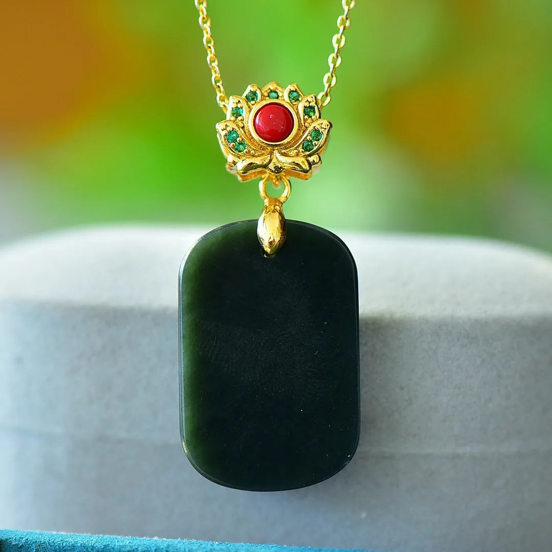 Flat Hetian gray jade pendant with copper inlay on a necklace chain.