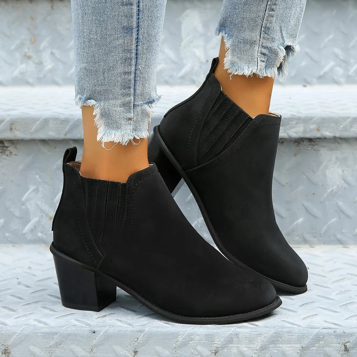 Women's black ankle boots with pointed toe, thick square heel and slip-on design