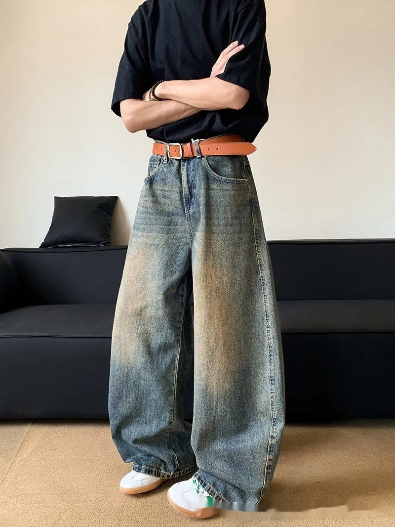 Men's retro blue distressed wide-leg jeans with a slimming fit through hips and thighs.