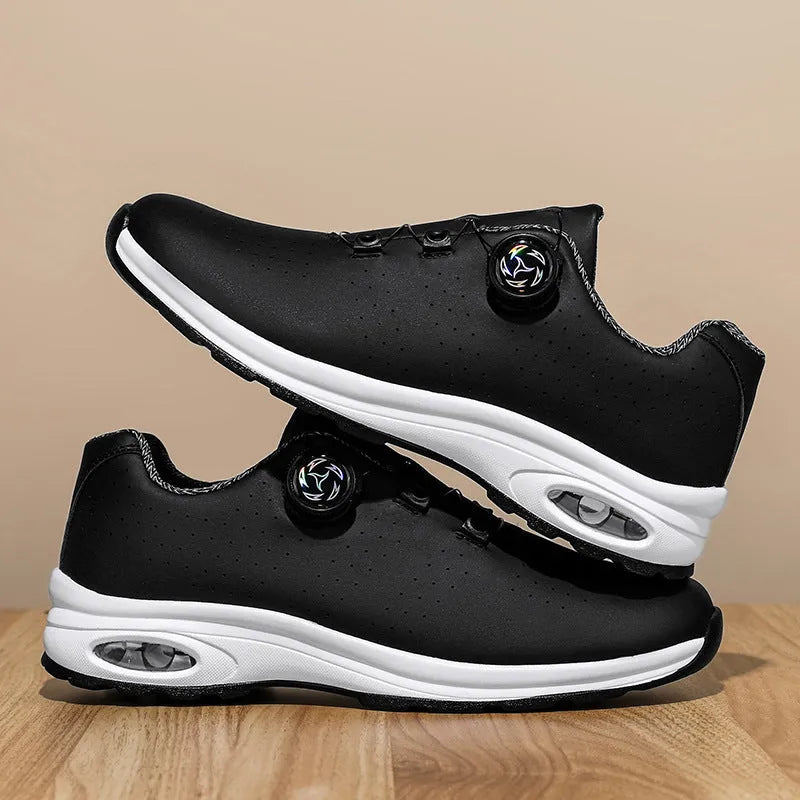 Black and white low top mesh tennis shoes with a round toe and flat composite sole on a plain background.