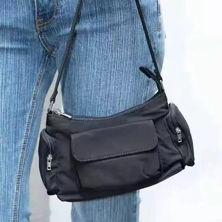 Black lightweight PU shoulder bag with two pockets and side-line detailing.