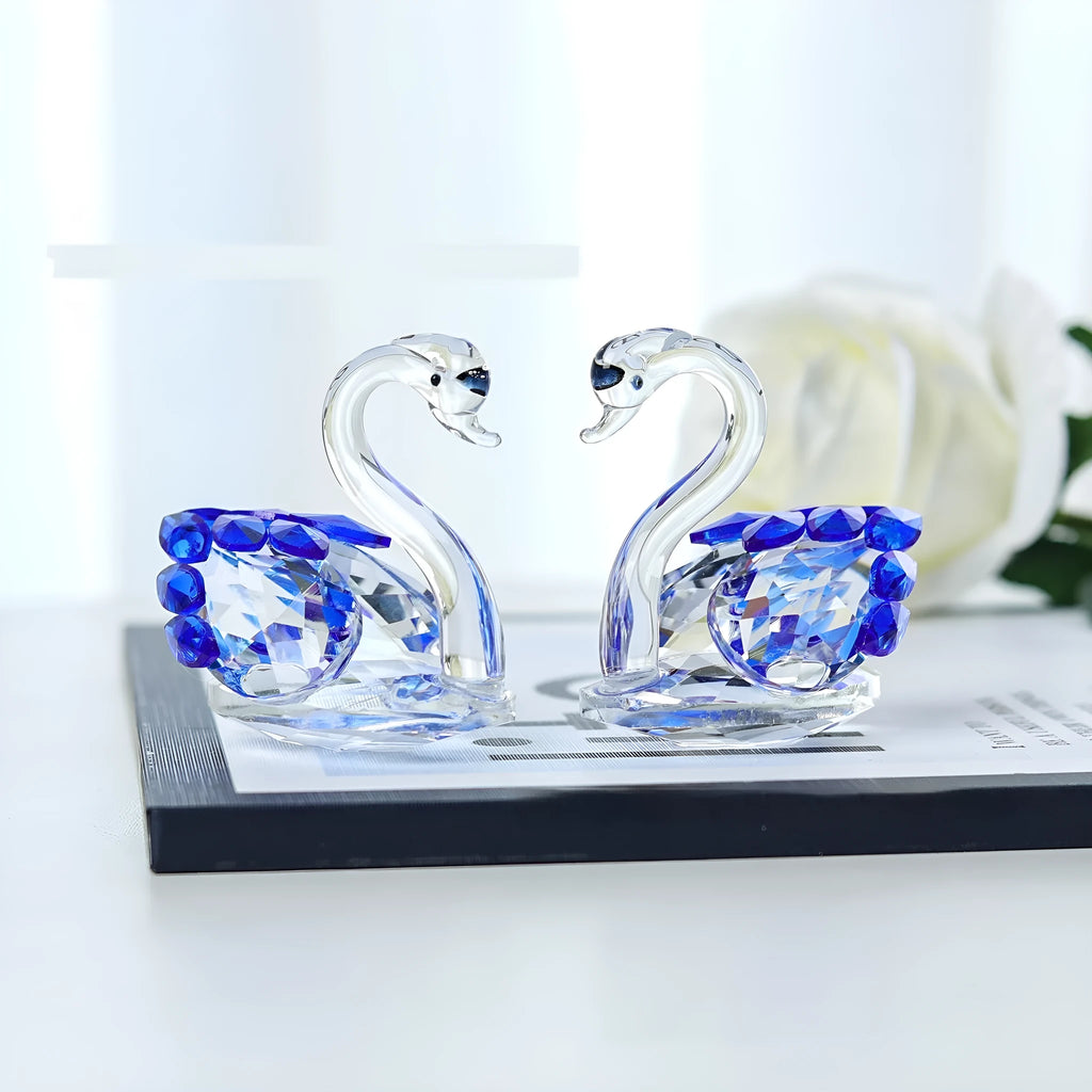 White crystal swan ornament in choice of red, blue, pink, or purple on a desktop