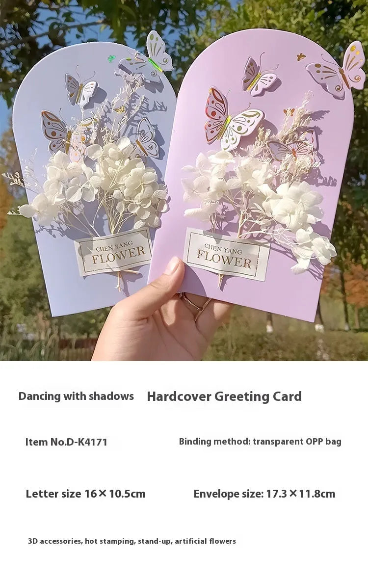 Handmade 3D boxed birthday card with butterfly shape and artificial flowers on coated paper.