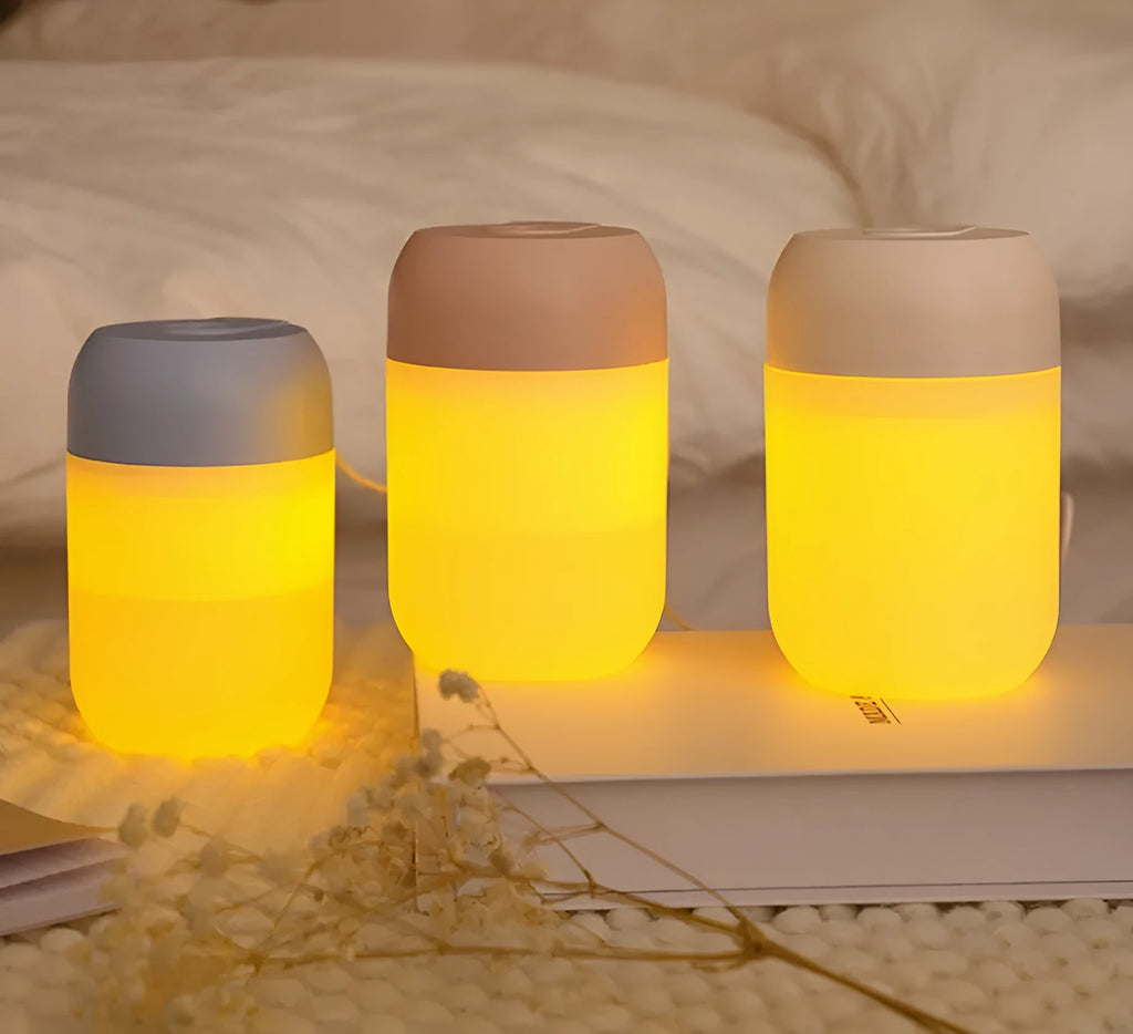 Small white cylindrical USB humidifier with charging cable on table