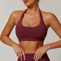 Black women's halter yoga bra with removable padding on a mannequin