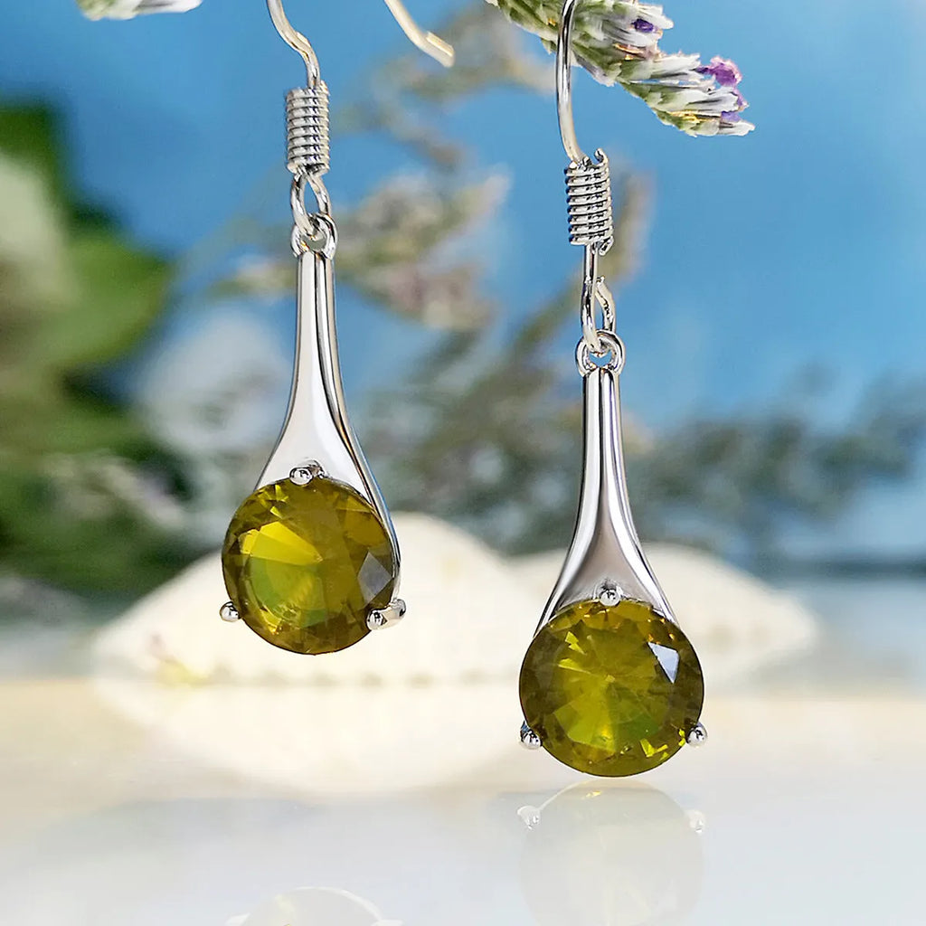 Olive green drop-shaped alloy earrings with posts on a white background.