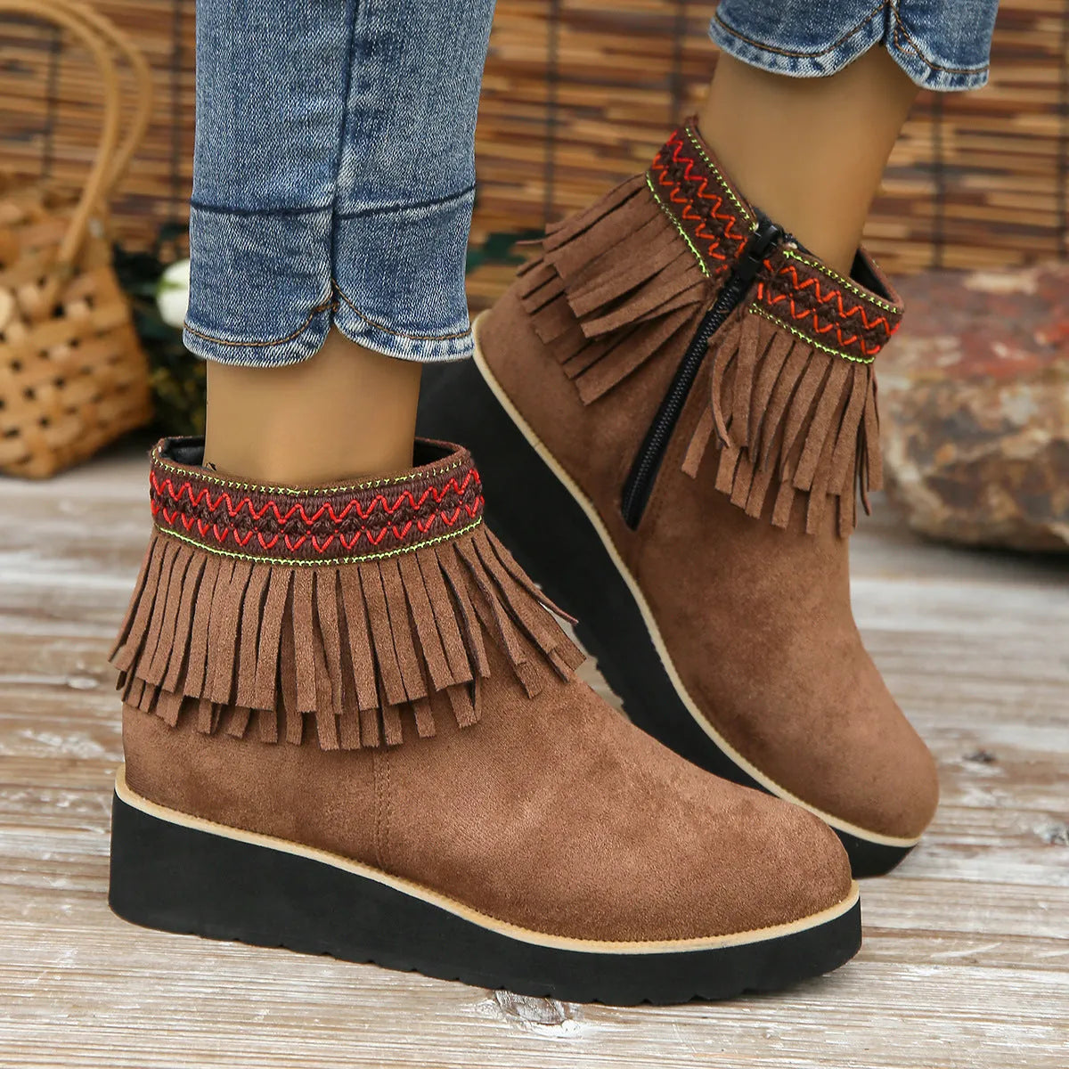 Women's suede wedge ankle boots in dark brown with a side zipper and tassel detail.