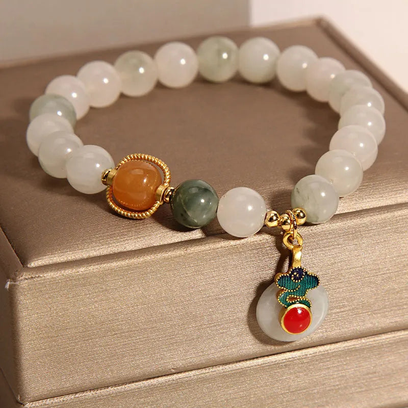 Women's ice jade crystal bracelet with pearl accents and retro design on display