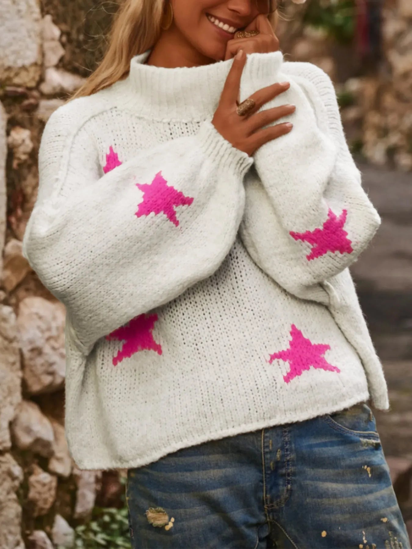White women's loose turtleneck pullover sweater with a thick imitation velvet fabric and a contrast colour five-pointed star pattern.