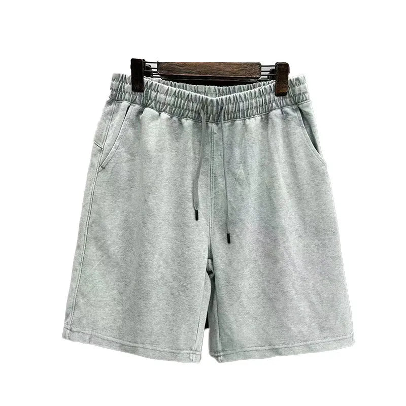 Men's navy blue distressed cotton shorts with a loose casual fit and straight legs on a plain background.