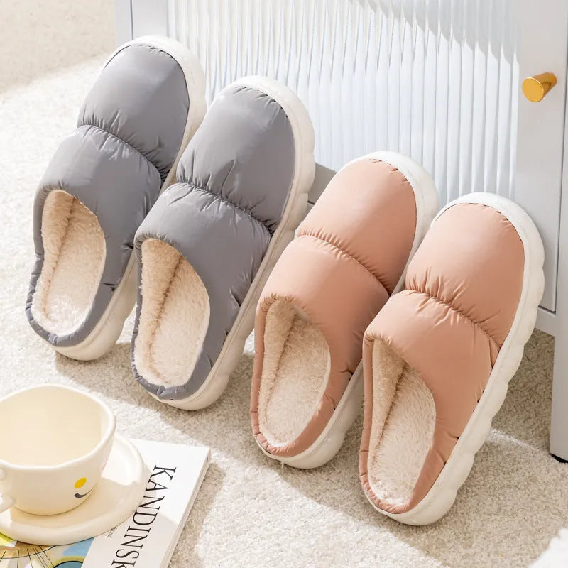 Blue winter house slippers with artificial leather upper, thick rubber sole, and plush lining on a wooden floor.