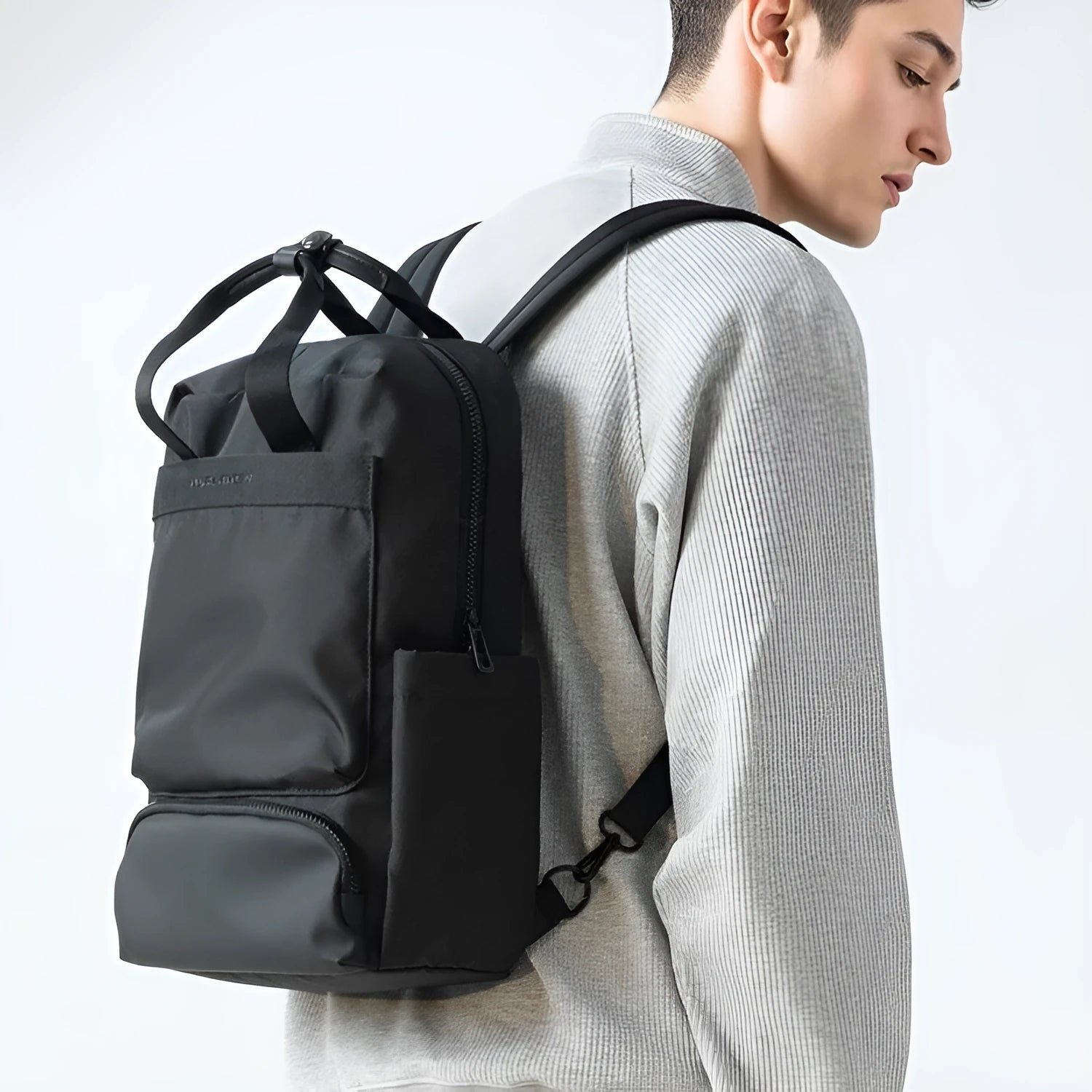 Black Oxford cloth computer backpack showing laptop compartment and storage organisation