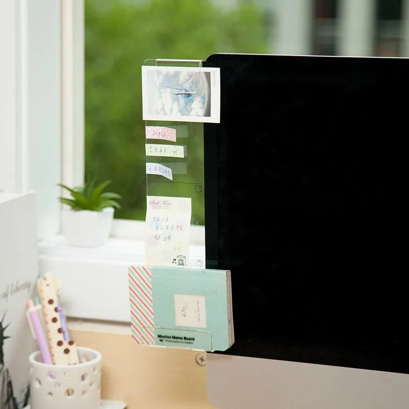 Clear acrylic memo board attached to a monitor with a post-it note on the surface