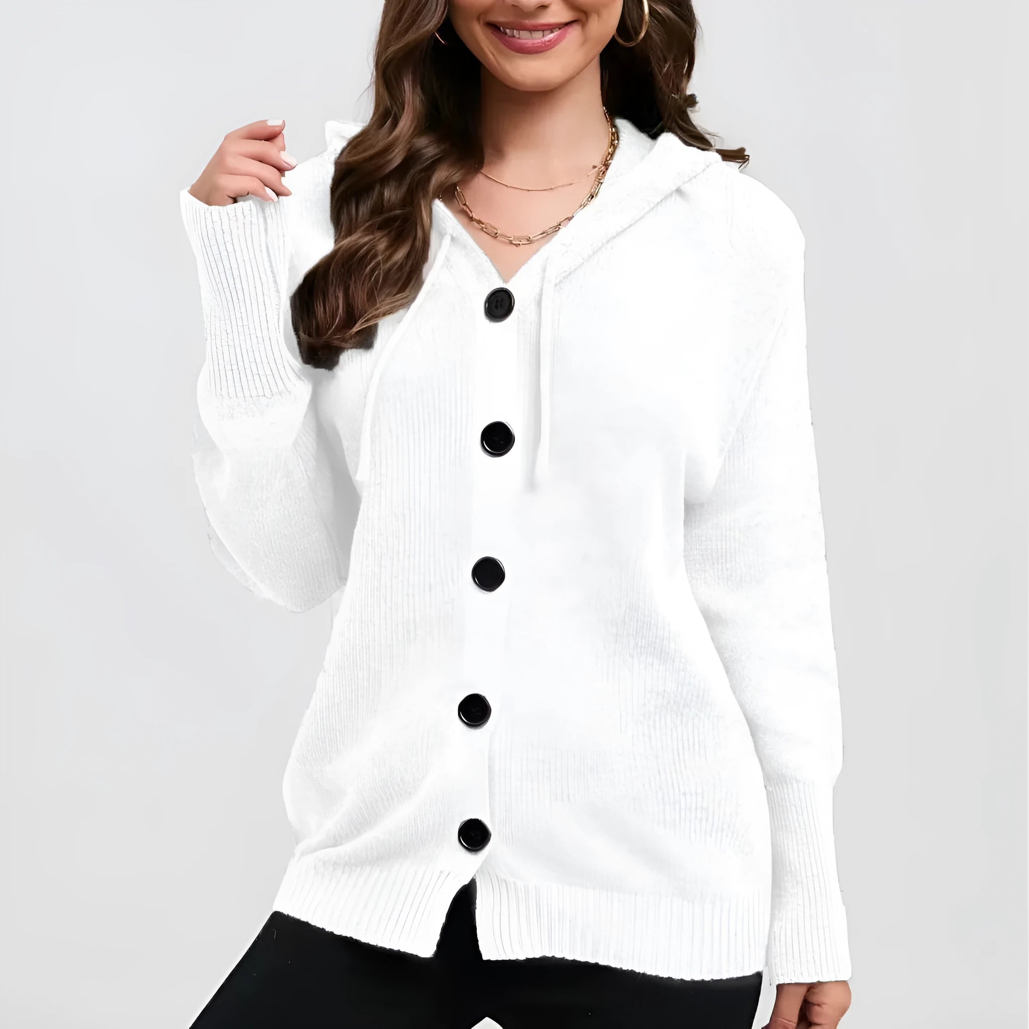 Woman wearing a thick, loose-fit hooded cardigan sweater in a solid colour.