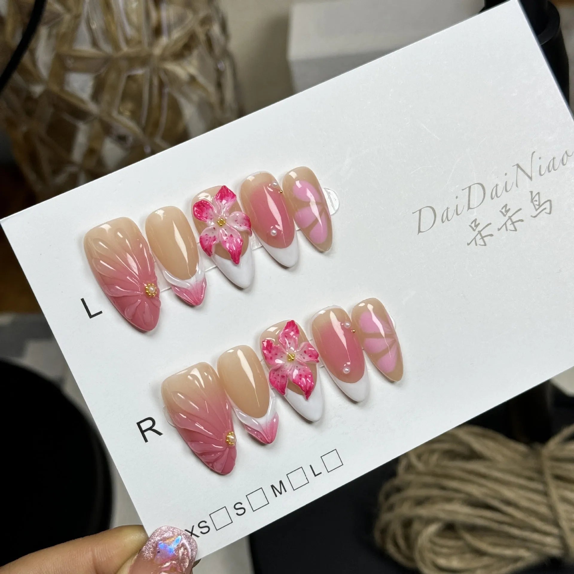 Plastic French style artificial nails with 3D lily and ice flower designs in almond shape, shown in multiple sizes.