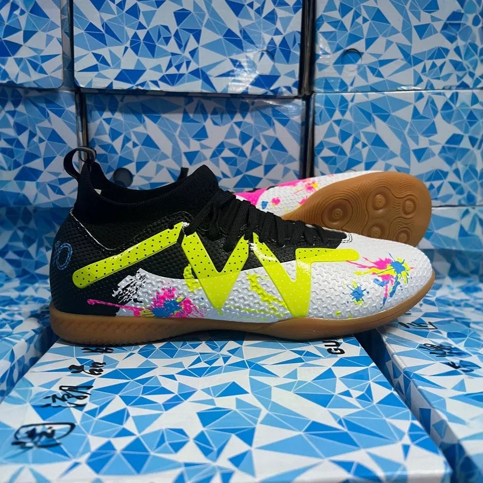 Low-top football shoes in black and yellow colour with PVC upper and rubber sole