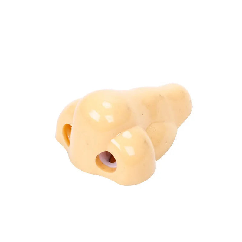 Flesh colour plastic pencil sharpener showing geometry design and large nostril hole
