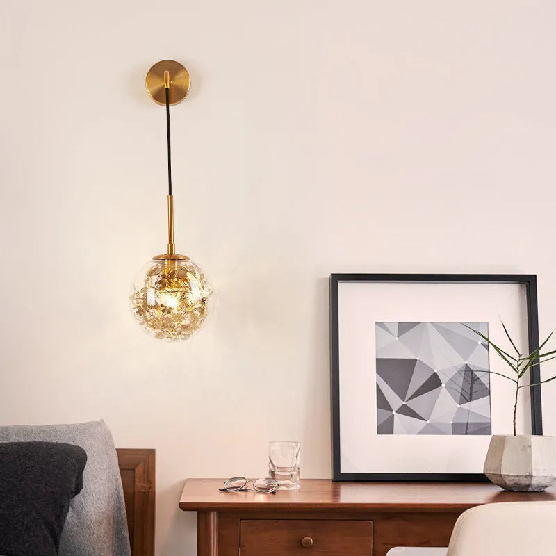 Modern glass wall lamp in golden flower finish, 20cm diameter, mounted on wall