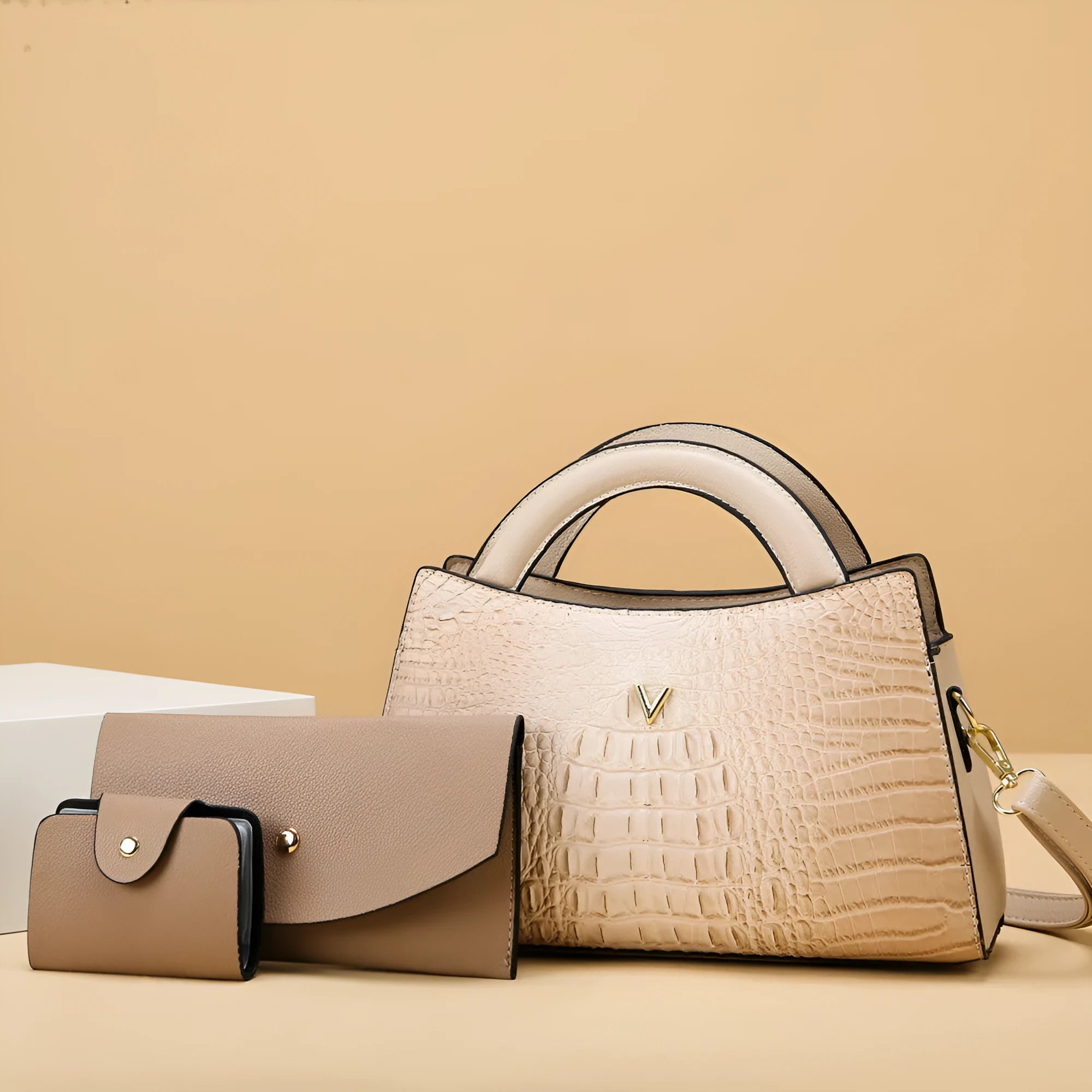 Square black women's crossbody bag with crocodile pattern texture and a single shoulder strap.