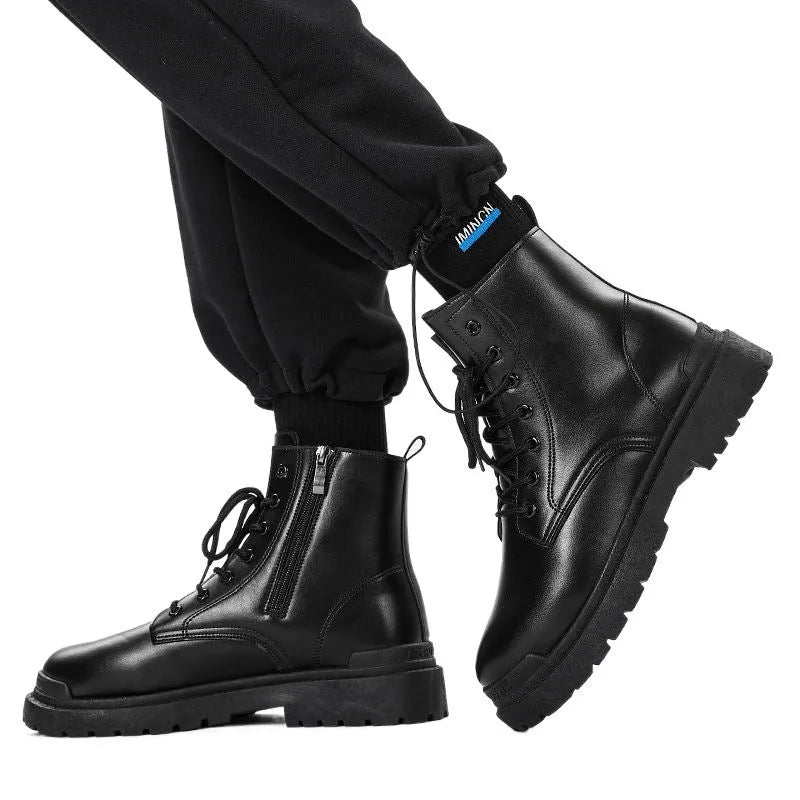 Men's black mid-top leather boots with a flat rubber sole shown from the side.