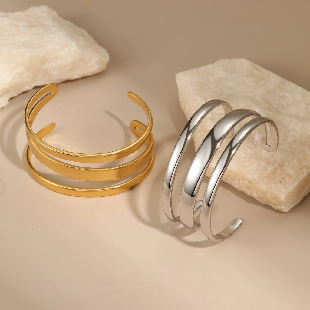 Stainless steel opening bracelet for women in gold or steel finish with geometric line design