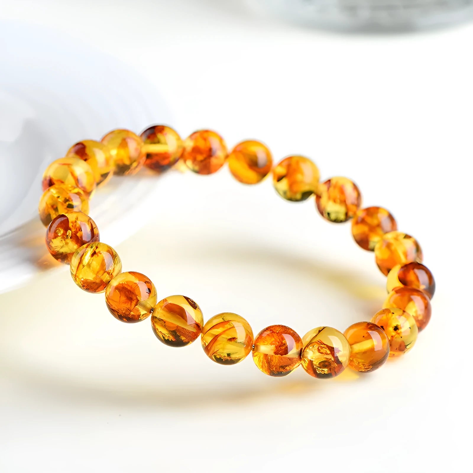 Natural yellow piebald amber bracelet with geometric beads showing distinctive flower spot patterning