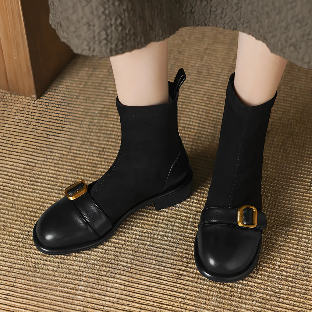 Black women's lace-up Martin boots with low heel and decorative belt buckle stitching on a white background.