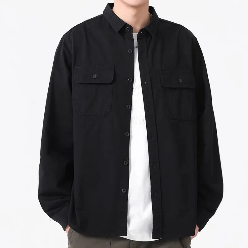 A man wearing a loose fit light grey long sleeve polyester cardigan shirt
