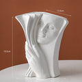 A glazed ceramic book stand in a modern design, holding a book upright on a desk.
