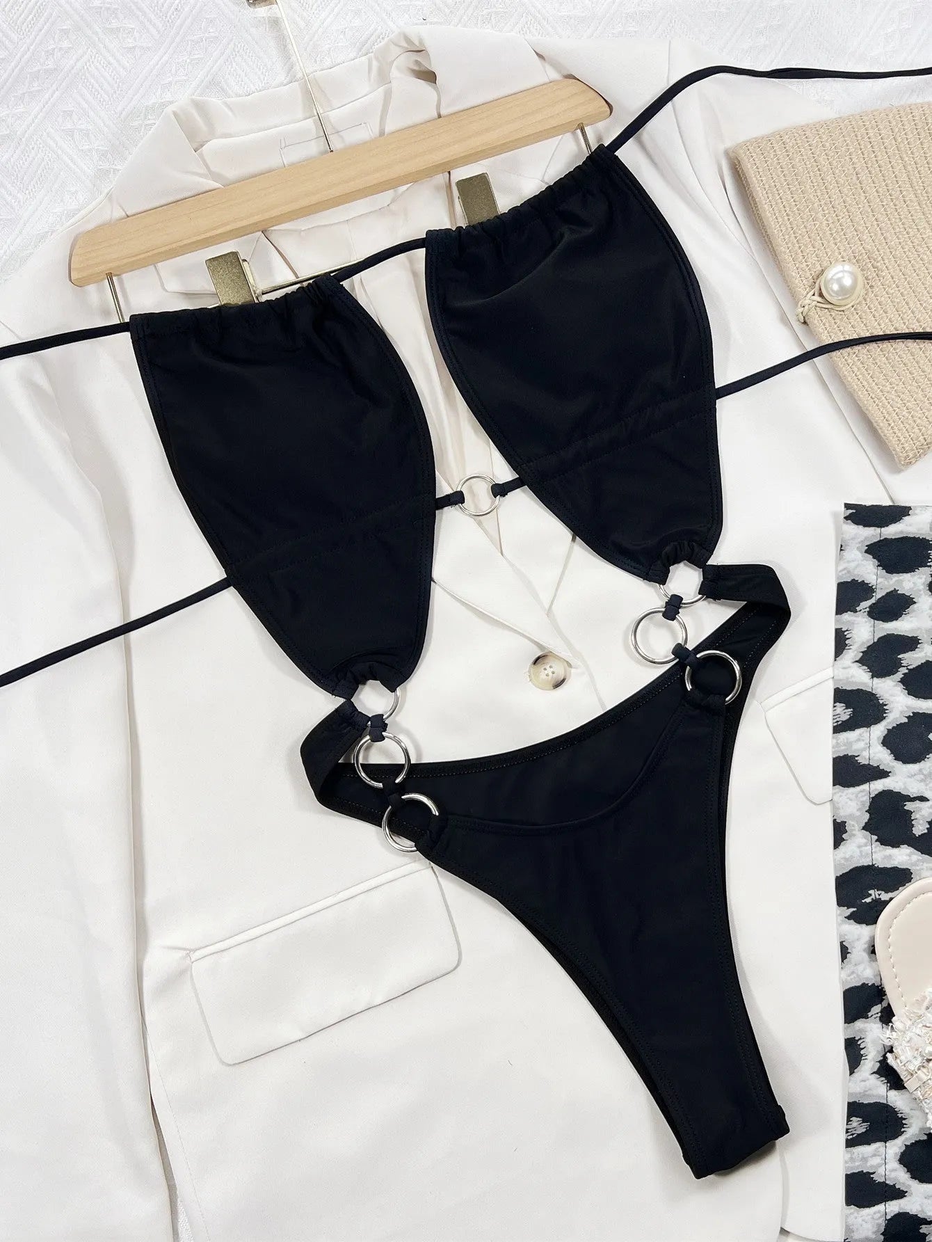 A solid black women's sleeveless one-piece swimming suit on a mannequin.