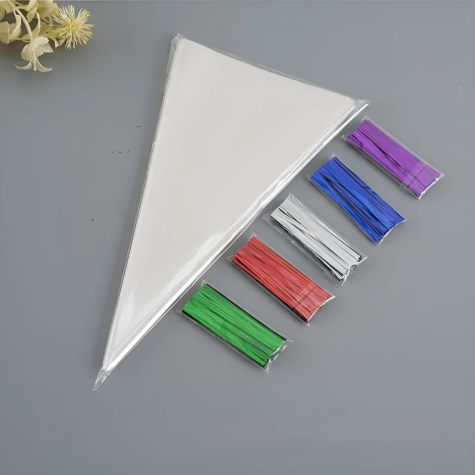 Clear triangle-shaped plastic packaging bag with a metallic twist tie at the top.
