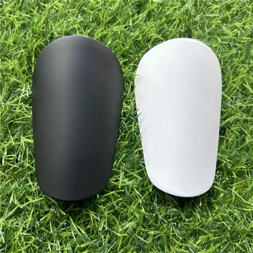 Extra small mini football shin guards measuring 8x5cm in black and white plastic