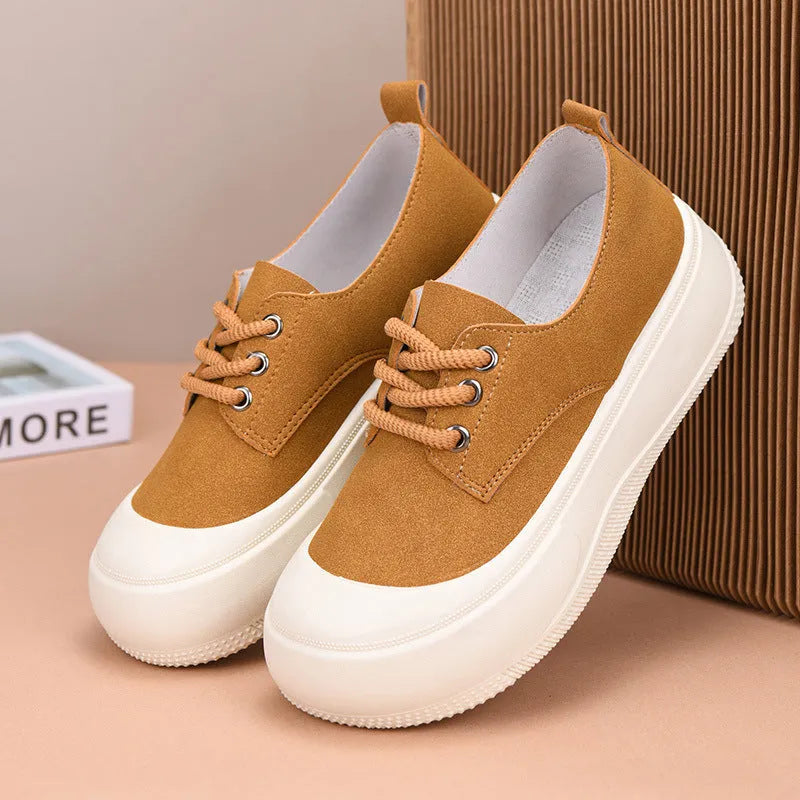 Women's camel suede platform loafers with round toe and front lace-up on a flat rubber sole.