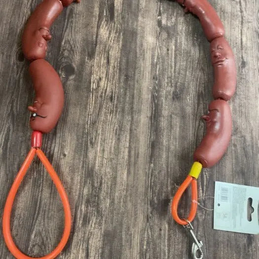 Brown three-section sausage rope toy 108cm long held by hand, pet tug and fetch rope