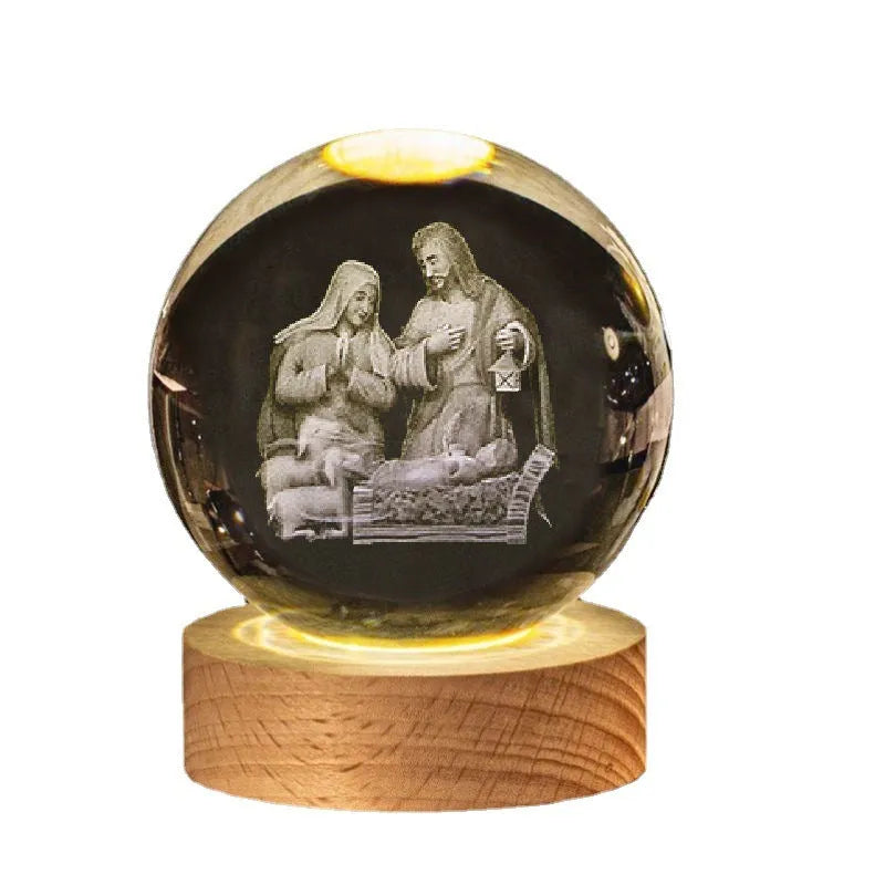 White crystal ball desk ornament with religious symbols on warm light wooden base