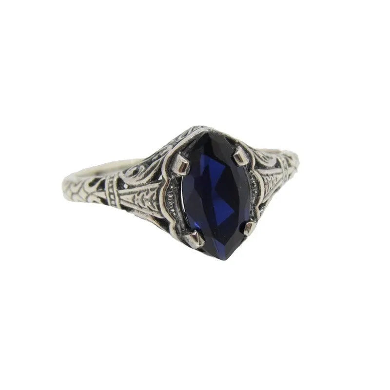 Silver alloy geometric hollow ring with zircon stone on white background, women's ring size 7