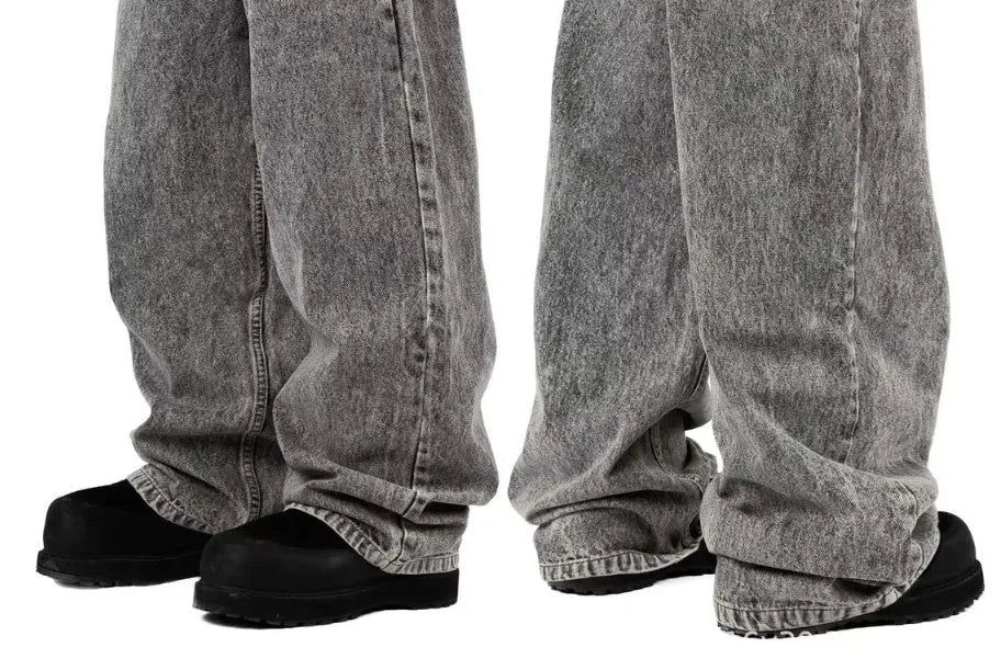 Grey loose fit straight-leg denim trousers for men and women on a neutral background