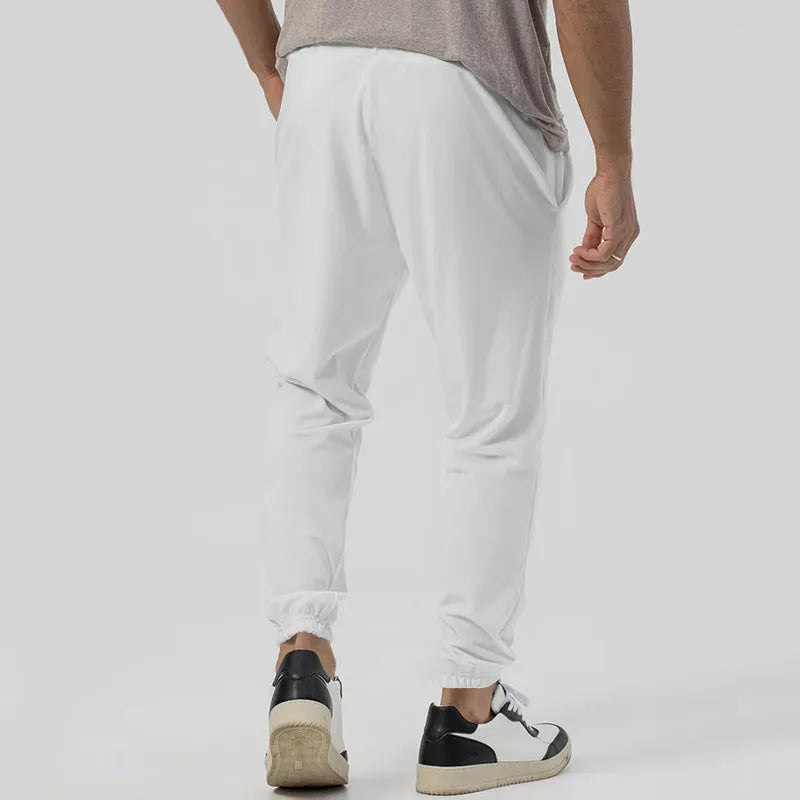 Men's casual track sweatpants in cotton blend fabric showing loose tapered straight-leg design in Army Green colour