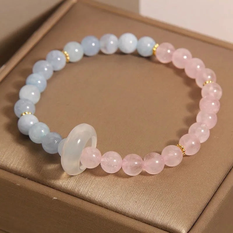 Women's aquamarine crystal bracelet with round geometric beads in mixed materials including natural pink crystal and imitation pearl