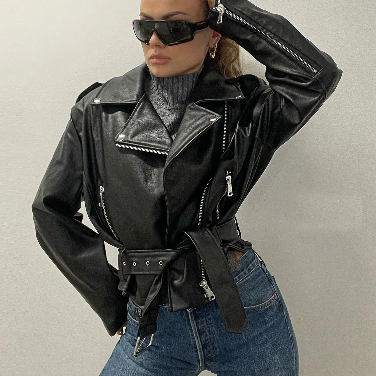 Punk style black leather jacket with Peter Pan collar, short belt, and drawstring waist.