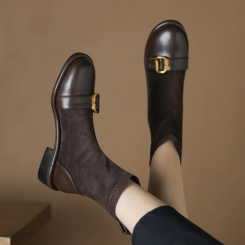 Black women's lace-up Martin boots with low heel and decorative belt buckle stitching on a white background.