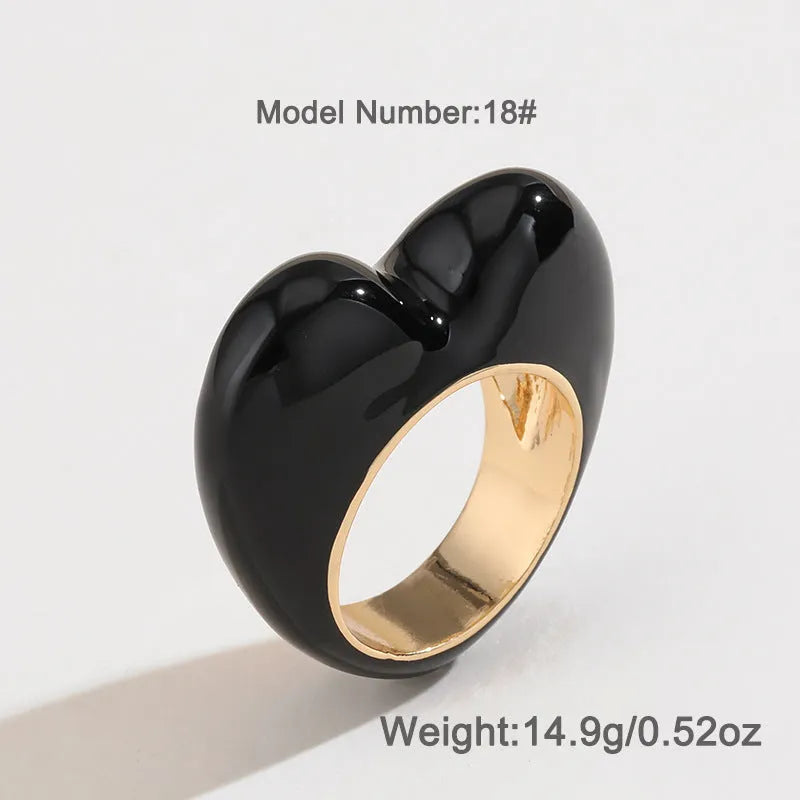 Three-dimensional heart-shaped enamel fashion ring in red, shown from the side.