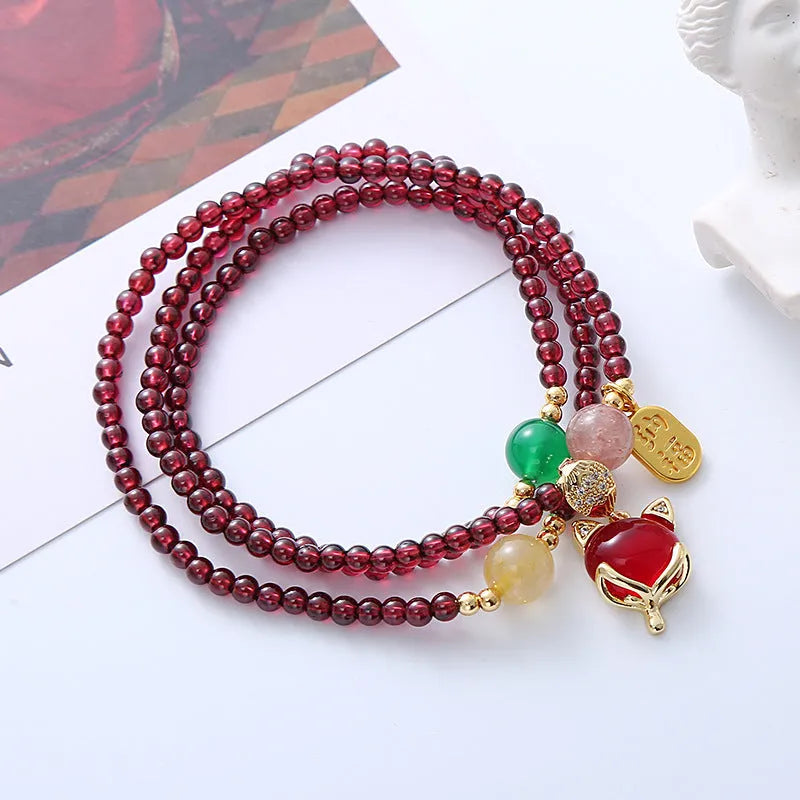 Natural crystal fox bracelet for women with purplish red garnet pendant on adjustable rope