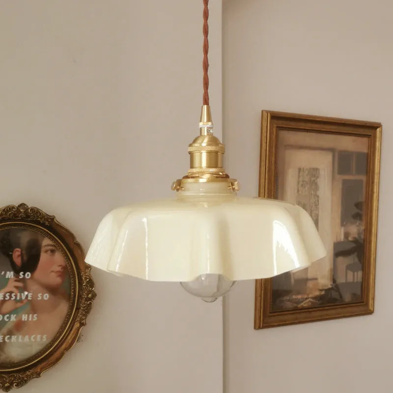 Medieval brass flower bud chandelier with cream finish and glass shade, showing height adjustment.