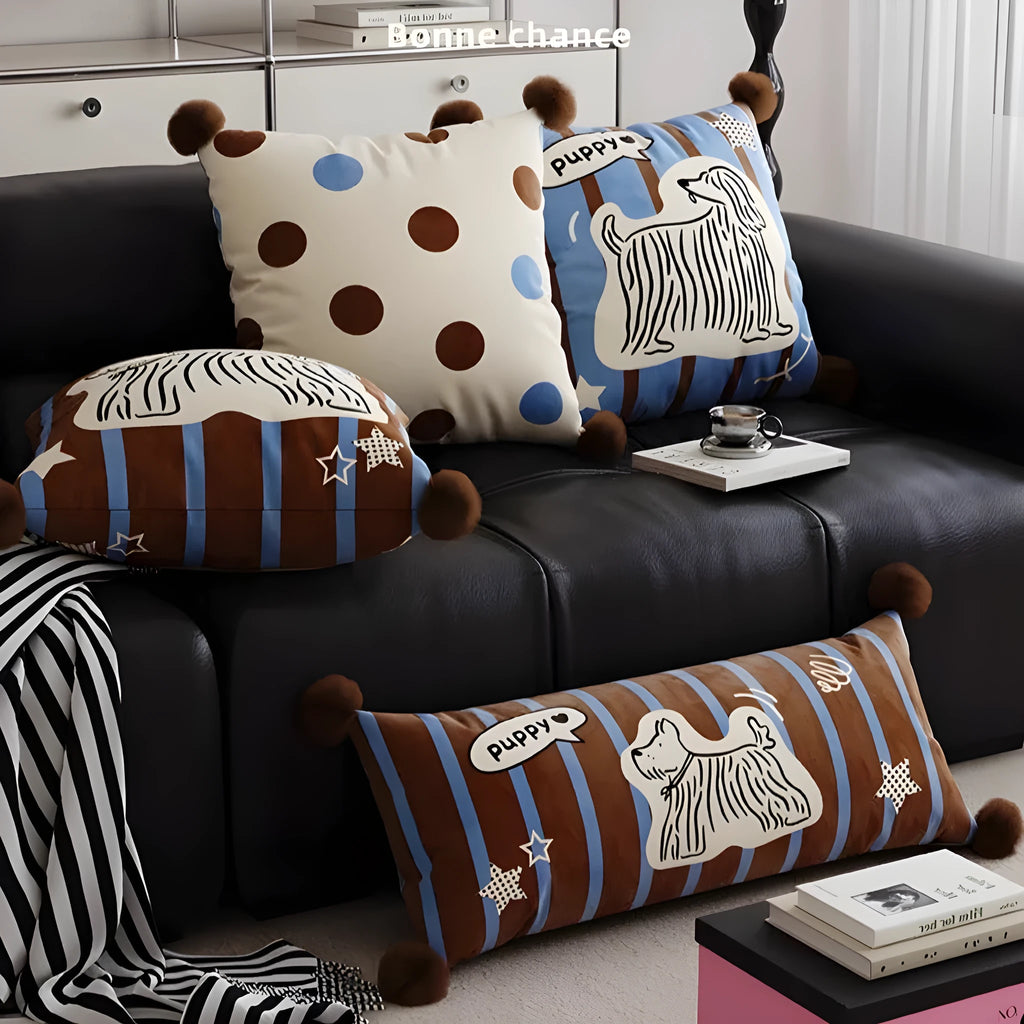 Blue cartoon animal print decorative sofa cushion pillow on a grey couch.