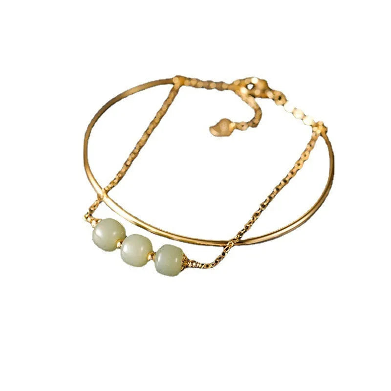 Hetian jade lucky beads bracelet with gold inlay, shown in women's fake two pieces style.