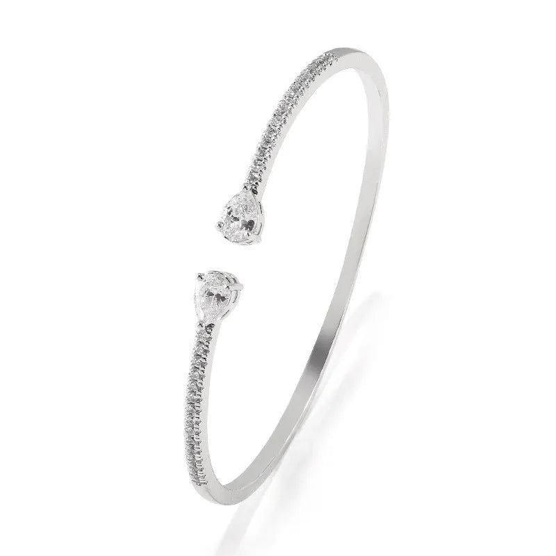 Copper bracelet with inlaid zircon detailing in simple style, shown in white and blue colour options.