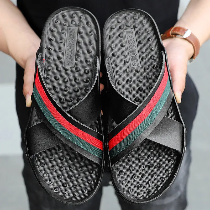 Men's cowhide leather flip-flops in black on a white background, showing the non-slip PU sole.